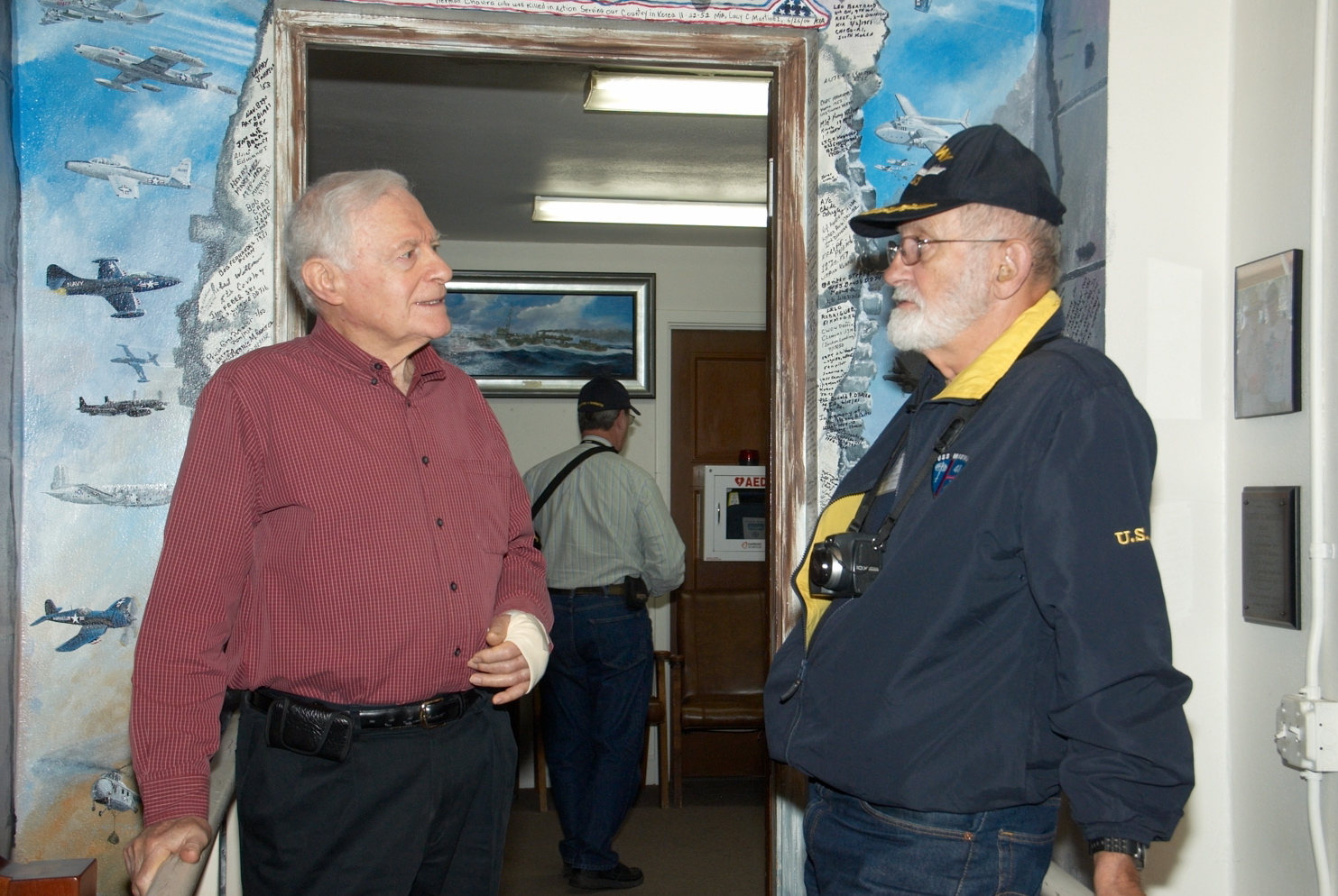 Captain Soules right, talking to the curator of museum