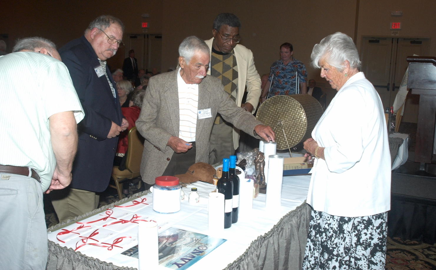 Attendees placing their tickets in the prize containers for the prizes they want to win